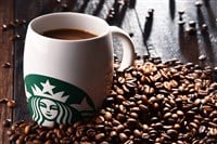 Composition with cup of Starbucks coffee and beans — Stock Editorial Photography